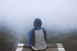 A silhouette emerging from fog — looking toward an uncertain future
